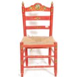 A folk Art / Barge Ware type low chair having a rush seat finished in red with floral and gilt