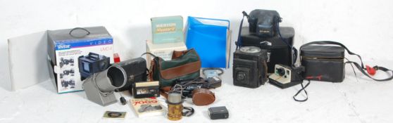 A collection of retro vintage video and camera equipment to include a Minolta 7000, A Polaroid