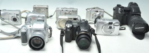 A collection of vintage digital cameras to include an Olympus Camedia C370, Fuji Finepix F700, Nikon