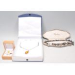 A collection of vintage jewellery to include a silver necklace having an amber cabochon pendant,