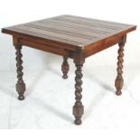 An early 20th Century oak drawer leaf dining table raised on barley twist supports with block