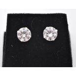 A pair of stamped sterling silver and a round brilliant cut CZ earrings with a 4 prong setting