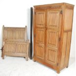 An early 20th century Jacobean revival carved oak double wardrobe and matching single bed. Each with