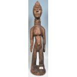 A carved African tribal wood fertility figure having a ringed neck and extended belly button, with