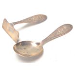 An early 20th Century 1930's silver hallmarked baby / child's spoon with pusher each having raised '