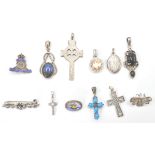 A collection of silver necklace pendants to include  ubique enamel military,  Victorian oval locket,