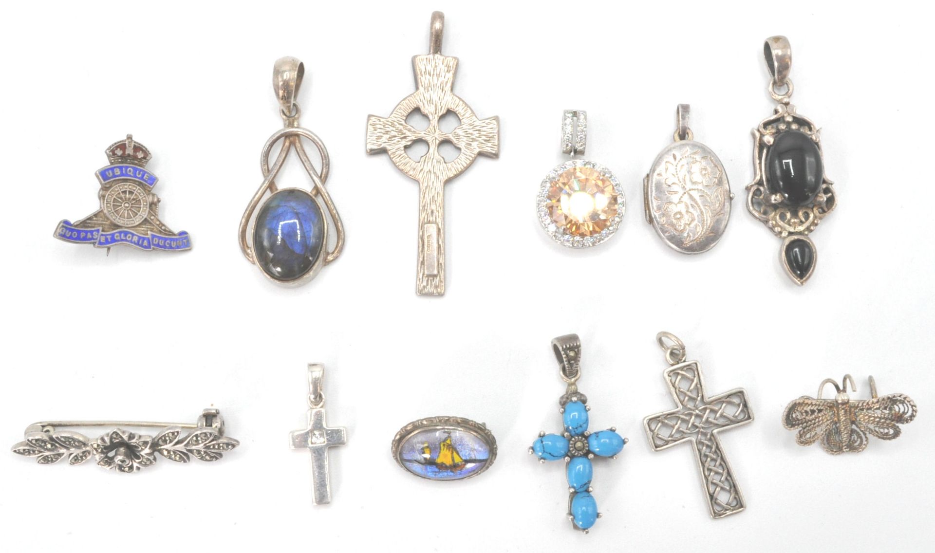 A collection of silver necklace pendants to include  ubique enamel military,  Victorian oval locket,