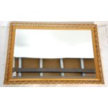 A 20th century antique revival good quality gilt framed and beveled edge overmantel mirror. The