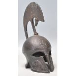 A vintage 20th Century heavy bronze Trojan Helmet having moulded rams head decoration. Measures 21cm