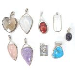 A collection of silver and agate set necklace pendants. To include turquoise, smokey quartz,