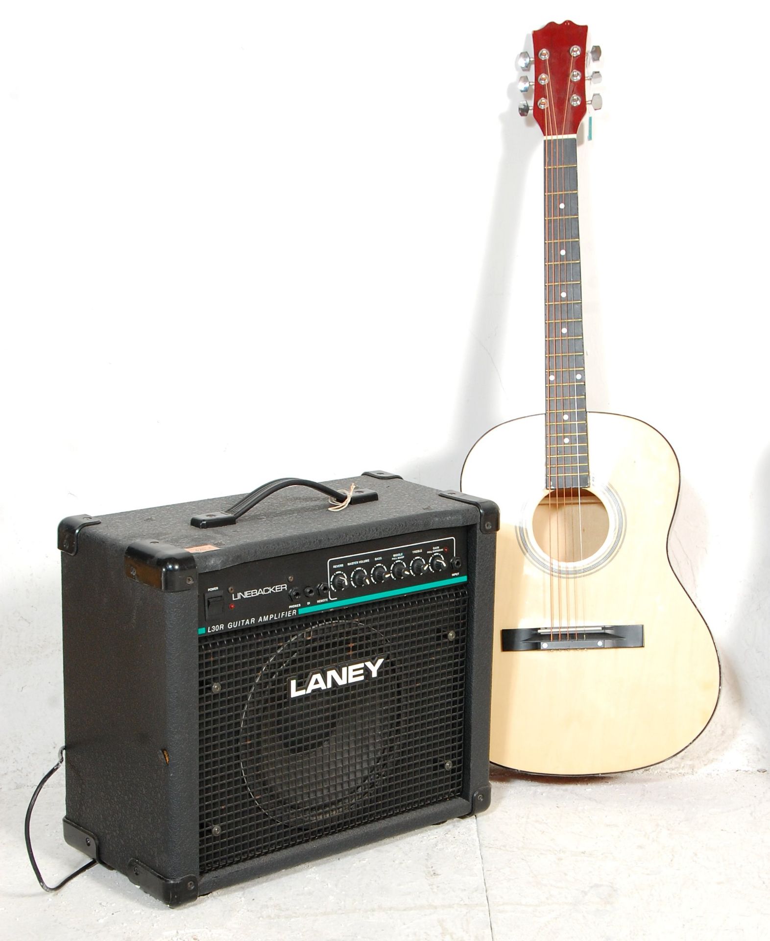 A vintage six string acoustic guitar having an inl