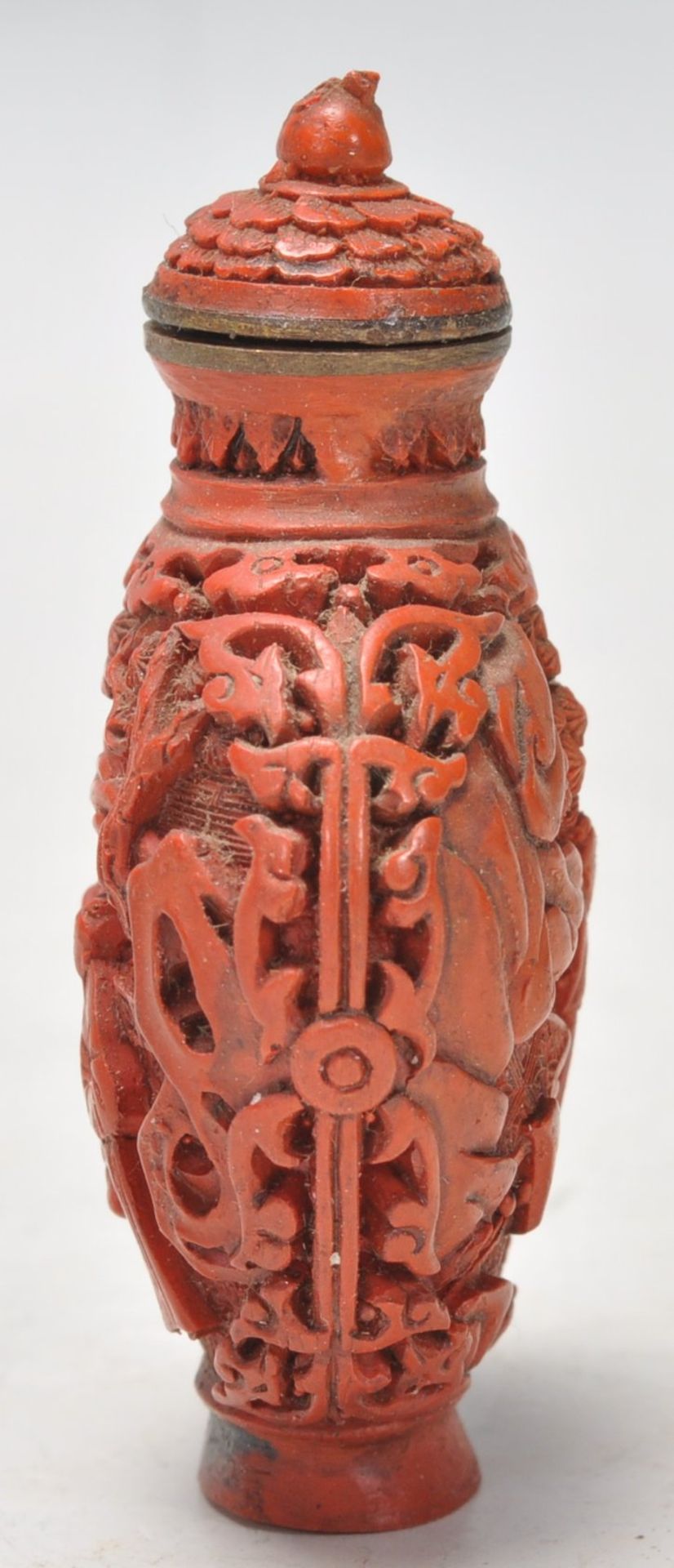 An Antique Chinese red cinnabar snuff bottle carved with landscape scenes and carved stopper atop. - Image 2 of 6