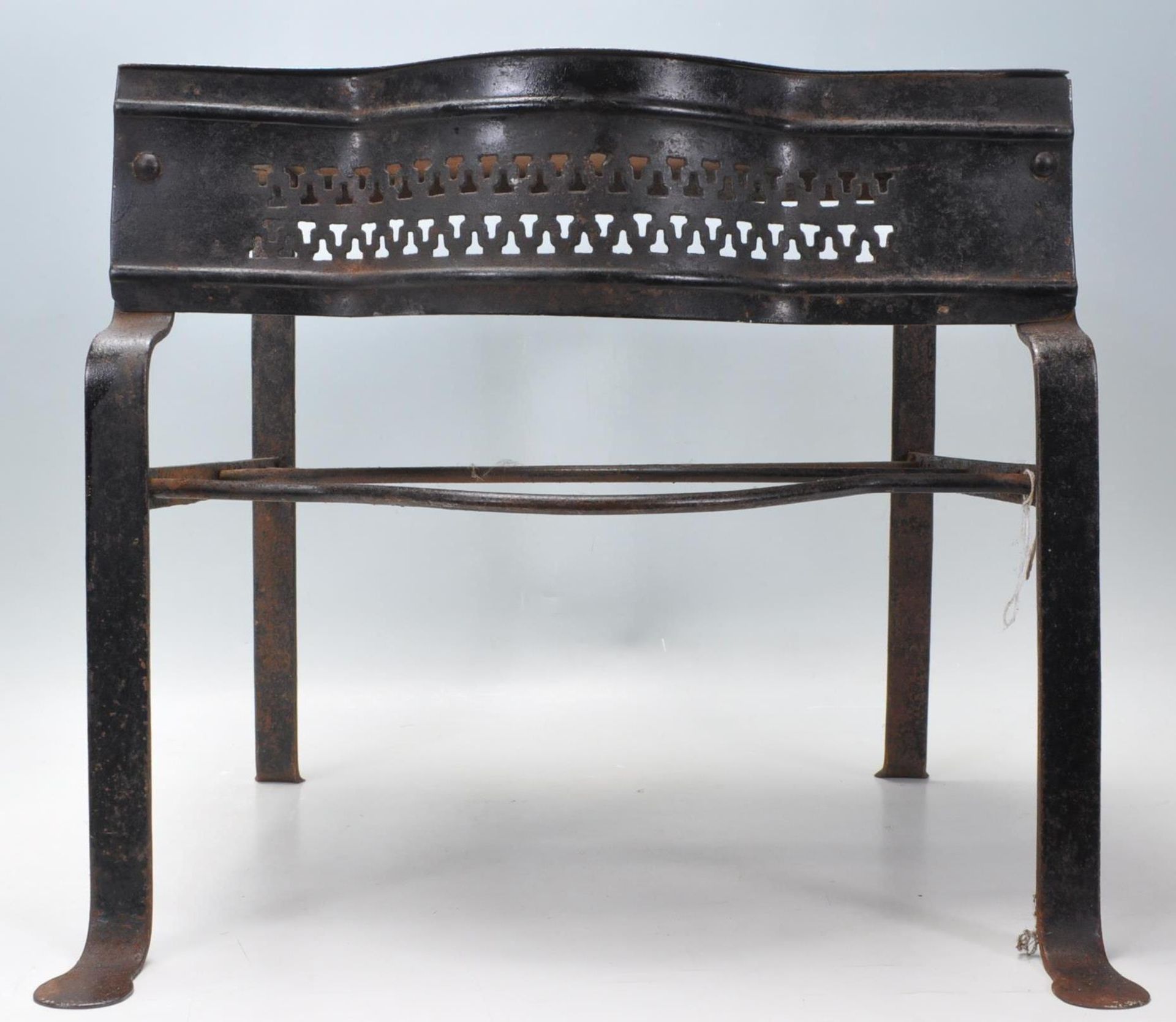 A 19th Century Victorian iron footman of simple form having a pierced gallery front and raised on
