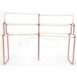 A vintage retro industrial 20th Century metal framed towel / shoe rack having a red painted frame