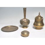 A collection of antique brass ware to include a Middle Eastern Islamic decorated lidded having
