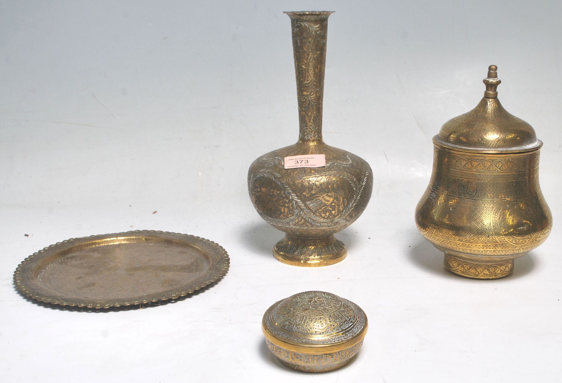 A collection of antique brass ware to include a Middle Eastern Islamic decorated lidded having