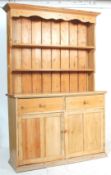 A 19th Century Victorian country pine dresser of good size raised on a plinth base with 2
