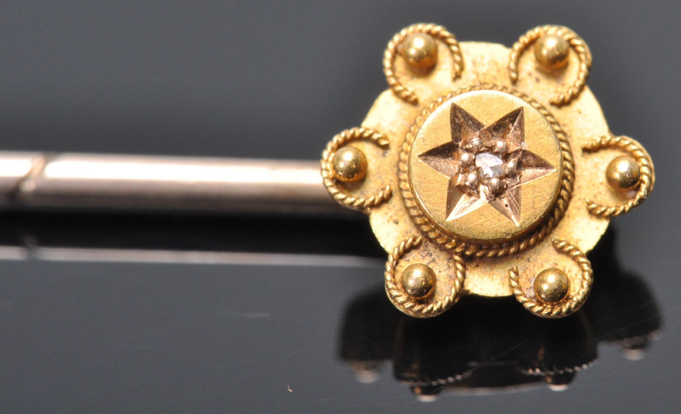 A 9ct gold toped tie pin having wire work and ball finial decoration set with a single diamond chip. - Image 2 of 5