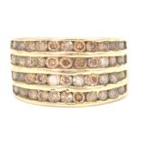 An early 20th century 18ct gold and champagne diamond channel set ring. The ring with 11 mixed cut