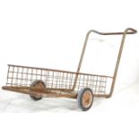 A vintage mid 20th Century industrial / factory trolley of metal tubular construction raised in