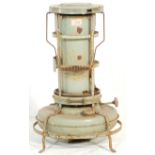 A vintage retro 20th Century metal paraffin heater by Aladdin of cylindrical form raised on a