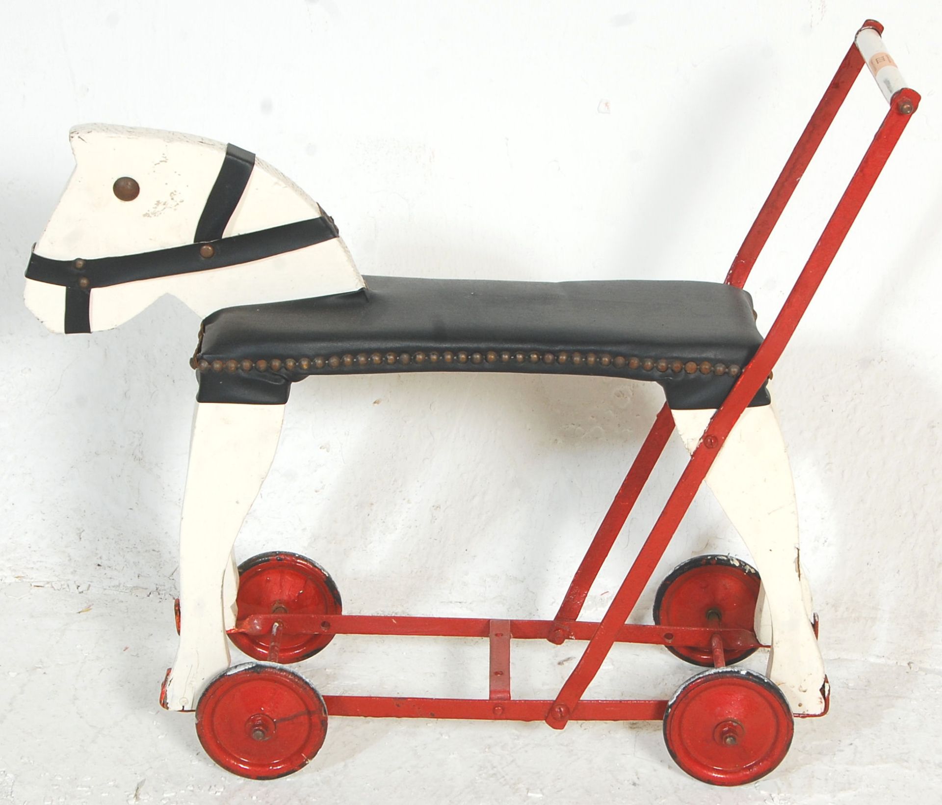 A vintage 20th Century push / ride along horse constructed form wood and metal finished in white and - Bild 5 aus 5