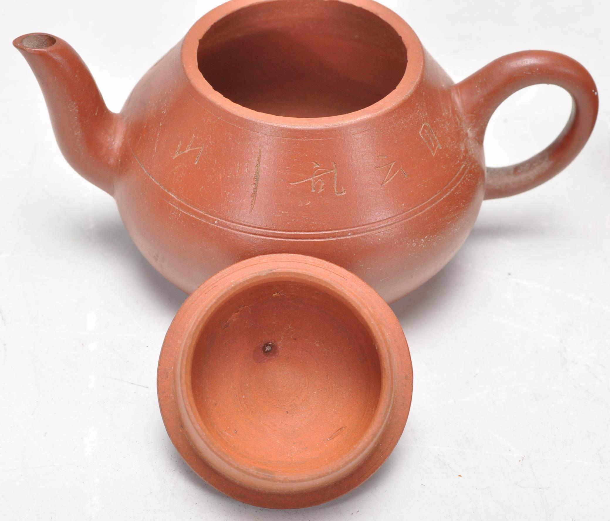 A collection of Chinese yixing teapots each of red clay terracotta form. To include a cylindrical - Image 6 of 12