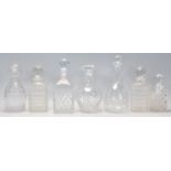 A group of seven vintage and antique cut glass decanters to include a pair of whiskey decanters with