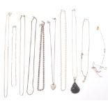 A group of silver necklace chains to include a fine link example having a heart locket pendant, rope