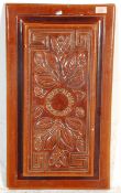 A 19th century Doulton Lambeth stoneware brown glaze plaque. Cast in relief with foliates and