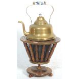 An antique early 20th Century brass kettle and warmer on a tapering wooden stand set on bun feet