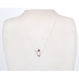 A stamped sterling silver and CZ pendant necklace in the form of a bee coloured in white and red