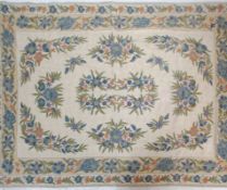 A 20th Century Indian Raj Period style wool floor rug / wall hanging having a cream ground with
