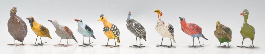 A set of 20th Century folk art bird figurines constructed from paper mache with wire work legs, each