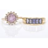 A 9ct gold hallmarked cluster ring. The ring with central round facet cut purple stone within a halo