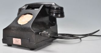 A vintage early 20th Century bakelite rotary dial telephone finished in black having a winding crank