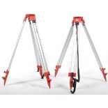 A set of 2 Leica 20th century wooden and cast metal surveyors tripod stands. Each with tapering legs