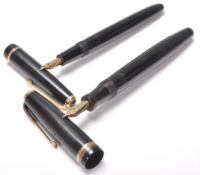 A pair of vintage Parker fountain ink writing pens, both having black bodies with gilt banding and