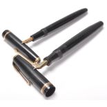 A pair of vintage Parker fountain ink writing pens, both having black bodies with gilt banding and