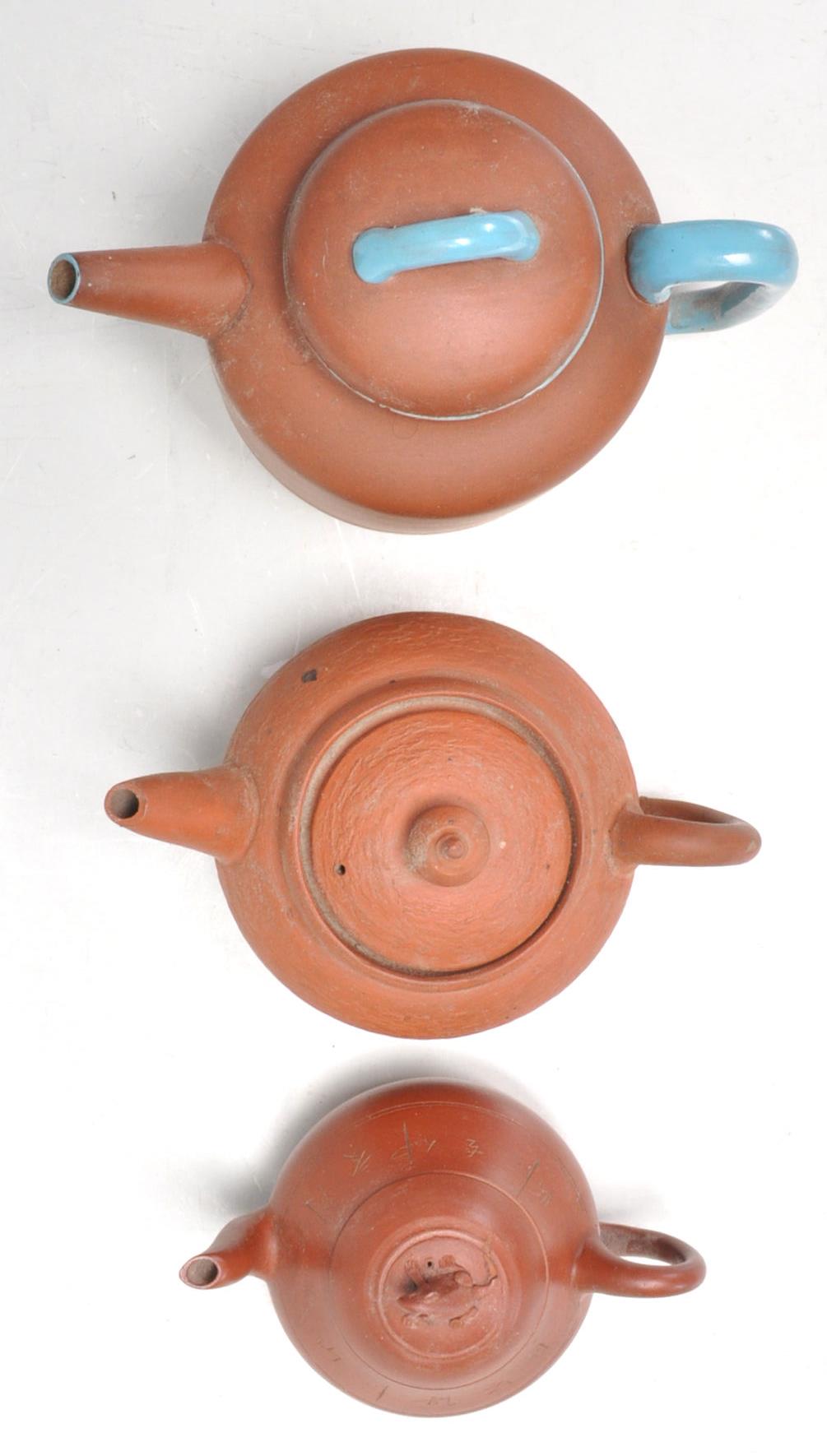 A collection of Chinese yixing teapots each of red clay terracotta form. To include a cylindrical - Image 5 of 12