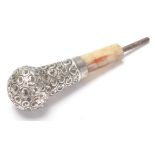 An antique Victorian hallmarked sterling silver and mother of pearl cane top decorated in foliate