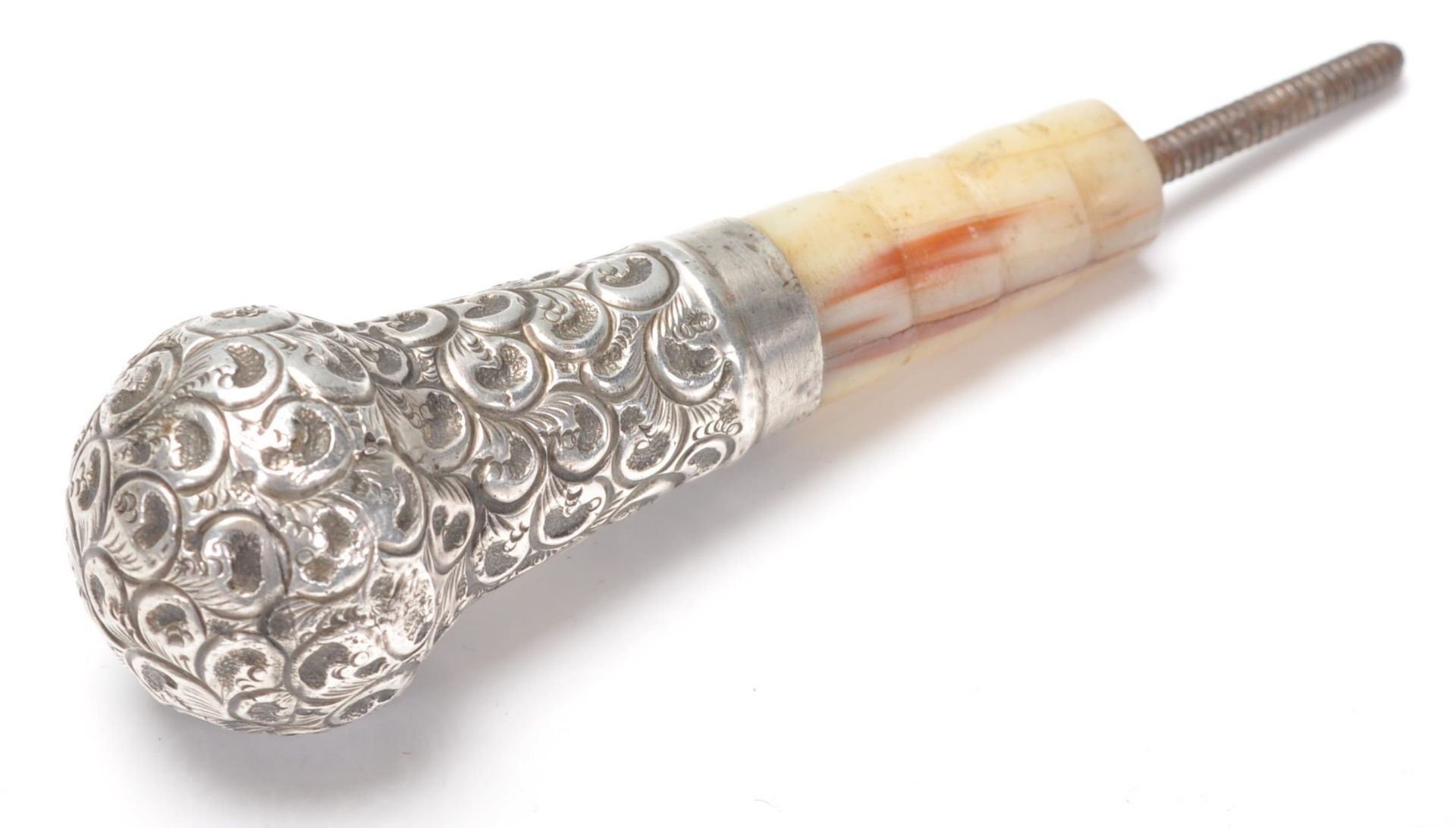 An antique Victorian hallmarked sterling silver and mother of pearl cane top decorated in foliate