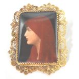 A 19th Victorian hand painted miniature of a hooded lady in the form of a brooch edged with filigree