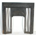 An antique Edwardian Art Nouveau Cast Iron Fireplace surround finely decorated with foliate swirls