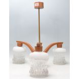 A retro mid century teak wood and glass 3 branch chandelier / electrolier. The chandelier with