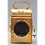 A mid 20th Century brass railway lamp lantern having a red glass front with glass sides. Embossed