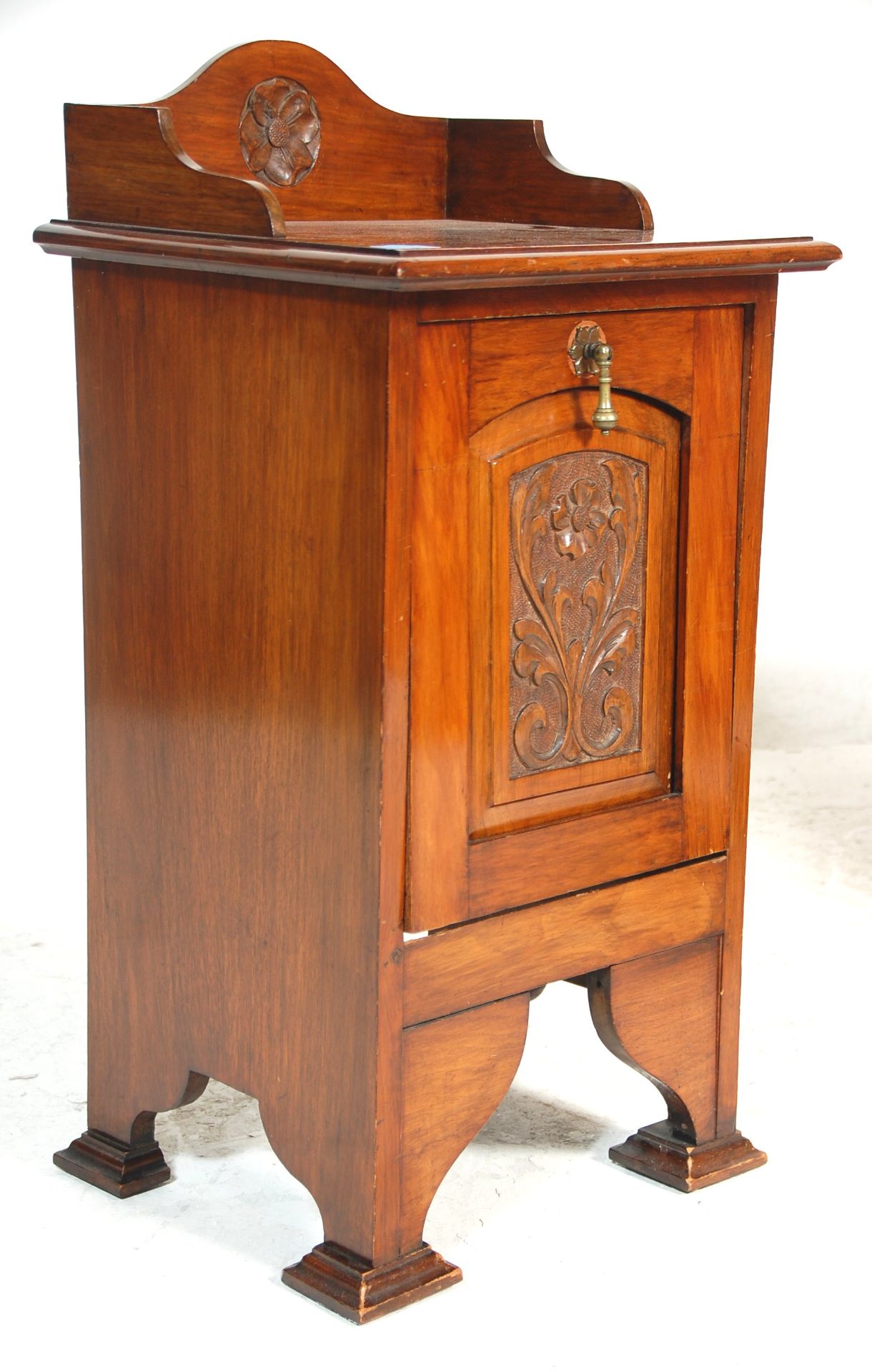 A 19th Century Victorian antique English mahogany country house fireside coal box having a carved