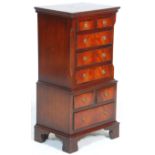 A Georgian revival small mahogany tallboy chest of drawers raised on bracket feet with a series of