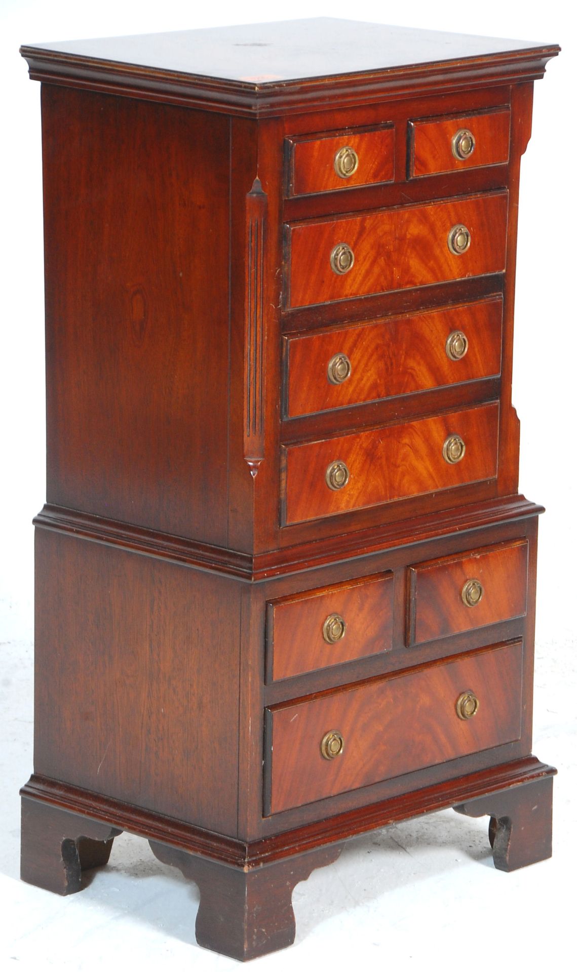 A Georgian revival small mahogany tallboy chest of drawers raised on bracket feet with a series of