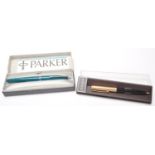 A vintage Parker ink pen having a turquoise plastic case and chrome arrow clip to the lid together